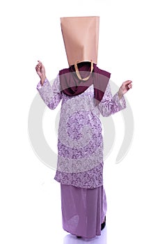 Woman hide her face with shopping bag