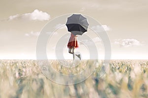 Woman hides behind his black umbrella in a surreal place photo