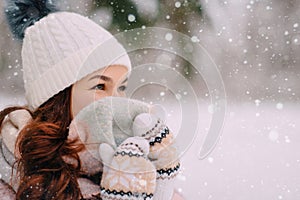 Woman hides her face behind scarf because of cold