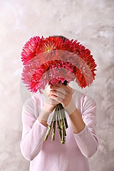 Woman hiding behind beautiful dahlia flowers