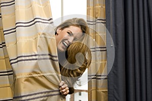 Woman Hiding Behind Curtains