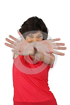 Woman hiding behind her hands