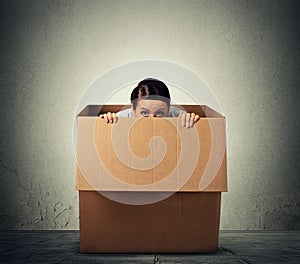 Woman hiding in a carton box photo