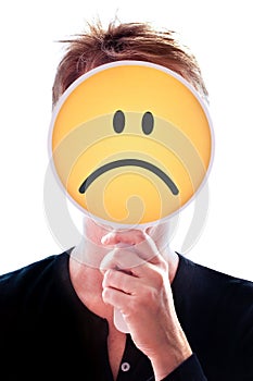 Woman hiding her face behind a smiley