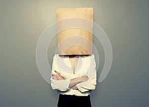 Woman hiding under empty paper bag