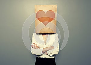 Woman hiding under paper bag