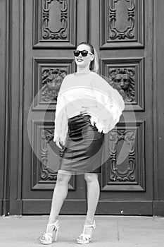 Woman in high heel shoes on red door in paris, france. woman in sunglasses with long hair. Beauty girl with glamour