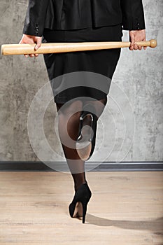 Woman on high heels hold baton