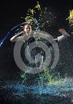 Woman High Kicking in Colorful Water Splashes