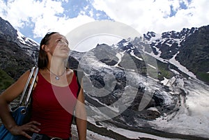 Woman high in the mountains, snow, glaziers, clouds