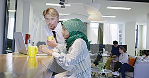 Woman with hijab meeting business man in startup office, healthy lifestyle in office, eating apple and fruits at office