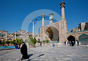 Woman in hijab rushes from Imam Khomeini Mosque built in early 18th with two minarets.