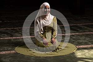 Woman in Hijab Sitting in Mosque and Praying