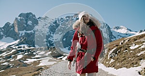 Woman hike in red jacket with backpack in winter journey mountain adventure