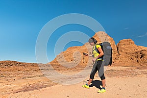 Woman Hiker with backpack and GPS