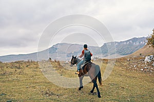 woman hiker with backpack riding horse landscape mountains fresh air
