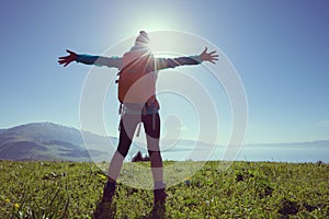 Woman hiker on beautiful green mountain hill top