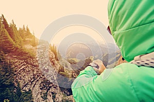 Woman hiker checking the altimeter on sports watch