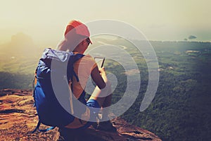 Woman hiker enjoy the view hiking on mountain peak