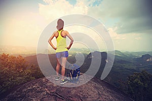 Woman hiker enjoy the view hiking on mountain peak