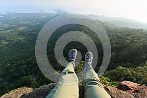 Woman hiker enjoy the view hiking on mountain peak