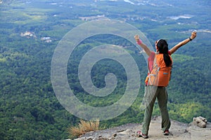 Woman hiker enjoy the view on mountain peak