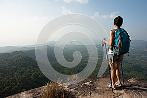 Woman hiker enjoy the view at mountain peak