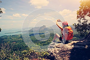 Woman hiker enjoy the view on mountain top cliff