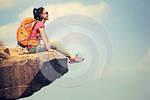 Woman hiker enjoy the view on mountain top cliff