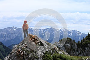 Woman hiker enjoy the view on mountain top rock