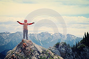 Woman hiker enjoy the view on mountain top rock