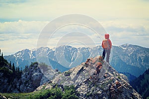 Woman hiker enjoy the view on mountain top rock