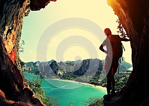 Woman hiker enjoy the view at sunrise mountain peak cliff