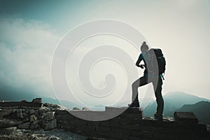 Woman hiker enjoy the view on the top of great wall