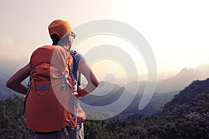 woman hiker enjoy the view on the top of mountain
