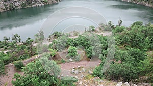 woman hiker enjoying view of old flooded mine