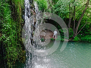 woman hiker enjoying view of waterfall