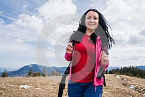 Woman hiker enjoys saffron blooming at Carpathian mountains