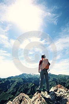 woman hiker hiking at beautiful mountain peak