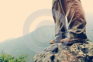 Woman hiker hiking at mountain peak