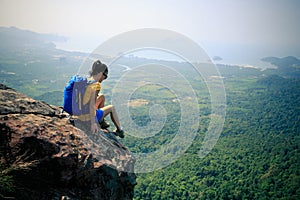 Woman hiker hiking on mountain peak