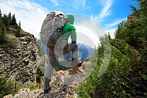 Woman hiker hiking on mountain top