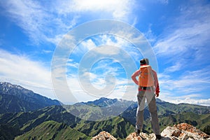 Woman hiker hiking on mountain top