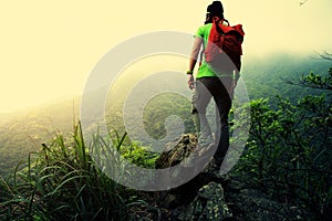 Woman hiker hiking at spring mountain peak