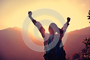 Woman hiker hiking stand on cliff