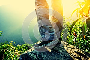 Woman hiker hiking stand on cliff