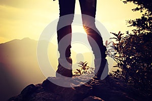 Woman hiker hiking stand on cliff