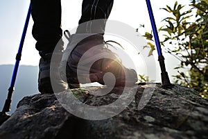 Woman hiker hiking stand on cliff