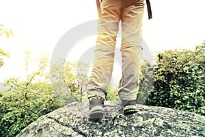 Woman hiker hiking stand on cliff