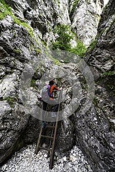 Žena tramp na žebříku na skalnaté turistické stezce v Prosiecké dolině, Slovensko